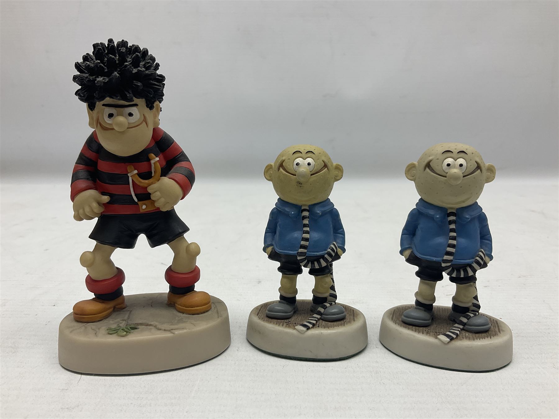 Eleven Robert Harrop figures from the Beano Dandy collection, comprising One Man & His Dawg BDS08, Picnic Desperate Dan BDS04, Fatty BD07, Desperate Dan BD03, Roger the Dodger BD20, Dennis the Menace BD01, Beryl the Peril BD05, Minnie the Minx BD04, Surfing BP03, two Spotty BD16, together with a Genuine Beano Ware lidded box (12)