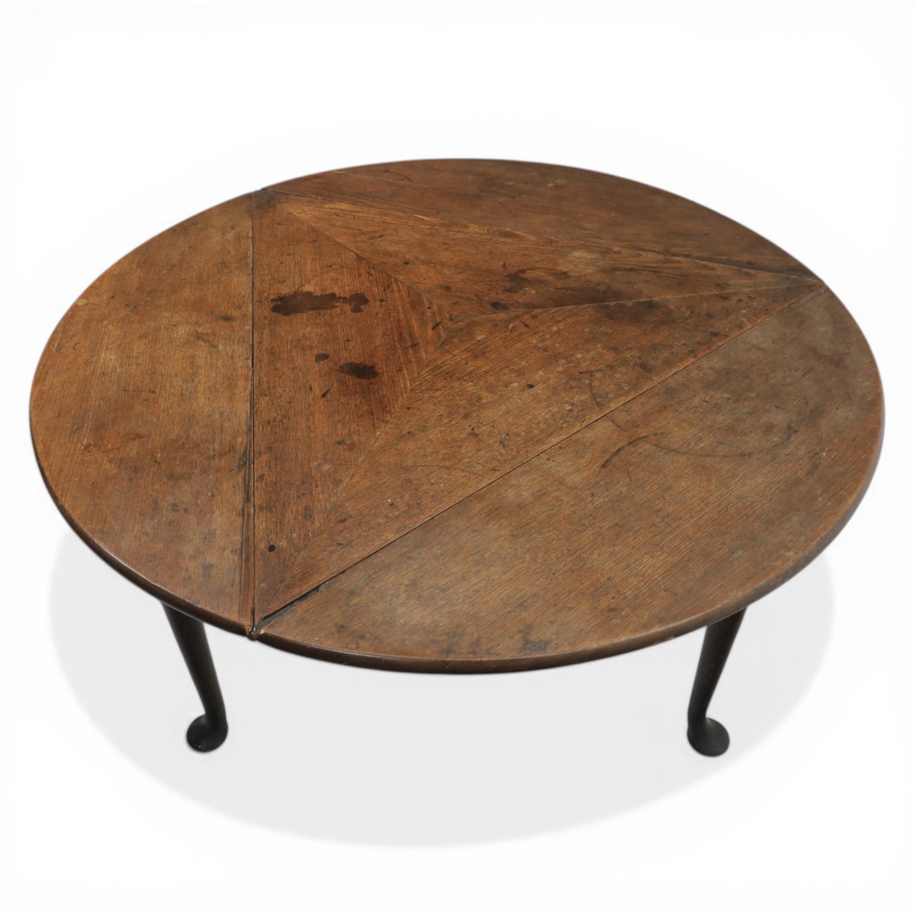 18th century oak folding cricket table, triangular top with three hinged demi-lune leaves, raised on tapering supports with pad feet