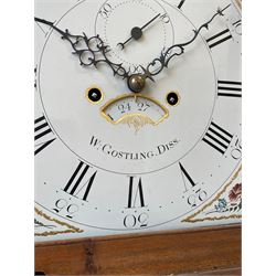 William Gostling of Diss  (Norfolk)-  Late 18th century 8-day oak longcase clock c1780-90, break arch top with scalloped cresting and three brass finials, glazed break arch hood door flanked by turned pilasters with brass capitals, trunk with a long trunk door and rounded top on a square plinth with an applied and shaped skirting, early painted Wilson of Birmingham dial with Roman numerals and five minute Arabic's, matching steel hands and second pointer, arched square ended calendar aperture with date disc behind, floral spandrels within gesso borders and a painted rocking automaton representing Mercury to the break arch, dial pinned via a false plate to a weight driven rack striking movement with a recoil anchor escapement, striking the hours on a cast bell. With pendulum weights and key. 
William Gostling (II) is recorded as working in Diss from 1774 to 1797, succeeded by widow Anne and son George . The dial of this clock is illustrated and discussed in detail in M.F. Tennants book 