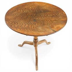 George III figured elm wine table with oval flip-top, raised on turned vasiform pedestal with tripod base