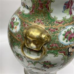 Pair of 19th century Chinese Famille Rose vases and covers, each of baluster form with twin gilt lion mask ring handles to shoulders, the flattened domed covers with gilt temple lion finials, each decorated with alternating reserves of bijin and attendants, and birds and butterflies amongst blossoming peonies, against a gilt ground profusely decorated with stylised scrolls, H32.5cm