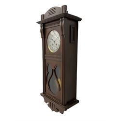 An early 20th century Art nouveau style wall clock with a French countwheel movement by Japy Freres, Paris, in an oak case with a shaped pediment, reeded mouldings and glazed panels, 7” silvered dial with a gilt slip and continental 24-hour Arabic numerals, minute track and steel spade hands, visible pendulum with a brass bob beneath, eight-day spring driven striking movement striking the hours and half-hours on a single gong rod. Movement and dial both stamped with the Japy Feres trademark.




