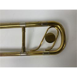 Three brass trombones comprising Elkhart Ind. USA 'CONN' model no.72H; Besson 'Concord'; and Selmer Distributed 'Lincoln'; two in carrying cases; and German B & M 'Champion' brass trumpet (4)
