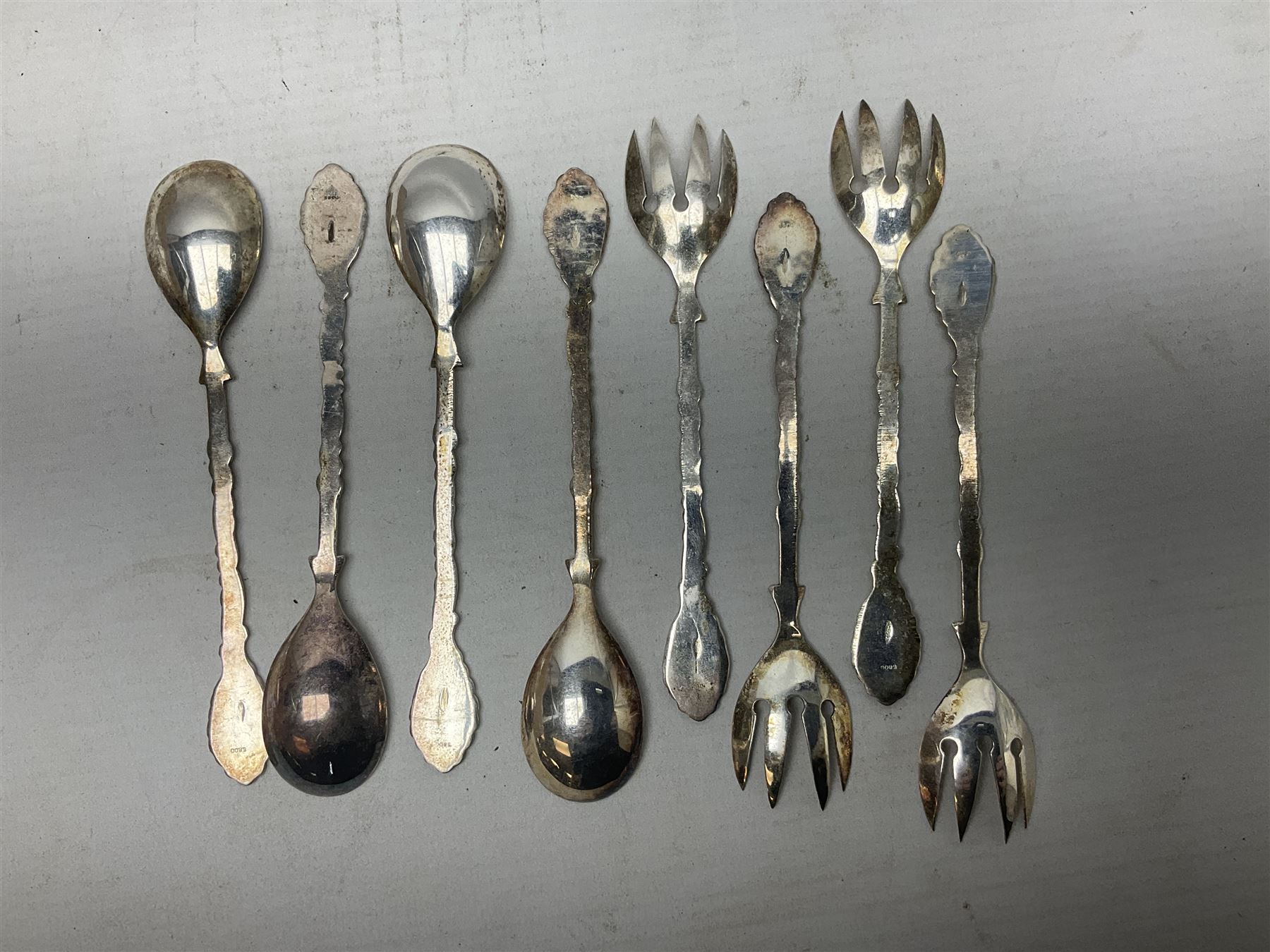 Set of four Continental silver spoons and forks, with stylised terminals, a number stamped S800, approximate weight 88.4 grams