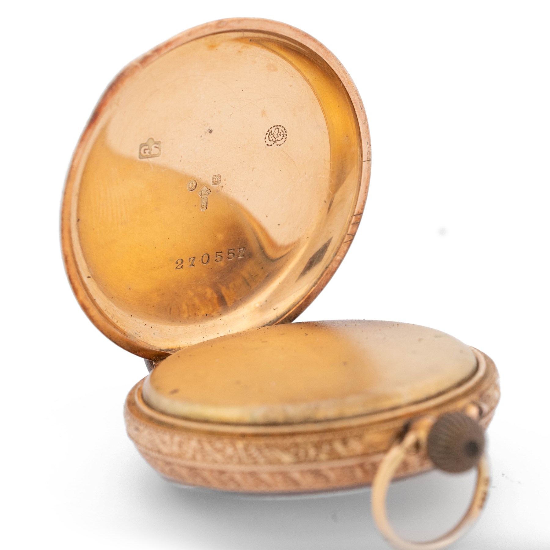Early 20th century 12ct gold open face cylinder fob watch, white enamel dial with Roman numeral hour markers and gold decoration, retailed by T. Fattorini, with 9ct rose gold lug attachment, case with engraved foliate decoration and empty cartouche by Stockwell & Co, London import mark 1909