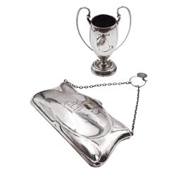 1930s small silver trophy cup, with twin whiplash curve handles, hallmarked Birmingham 1932, maker's mark WM, including handles H10cm, and an early 20th century silver mounted coin purse, with finger chain and engraved monogram to front cover, opening to reveal compartmentalised interior, hallmarked Turnbull Bros, Birmingham 1913
