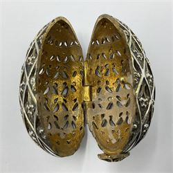 Modern silver limited edition Easter egg, no. 70/500, the openwork lattice body decorated with gilded panels of flower heads, opening to reveal a gilt interior, upon silver stand with three scrolling pad feet, each hallmarked St James House Company, London 1979, height including stand 8cm