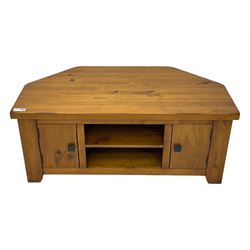 Contemporary mango wood television stand, wide planked surface and angled back corners, central shelving section flanked by twin cupboard doors with square pull handles, raised on stile supports