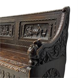 19th century carved oak box-seat hall bench, foliage carved upper rail over two panels carved with Flemish design tavern scenes, shaped down-swept arms carved with scrolling foliage and winged bird mask terminals, hinged seat carved with further scrolls and leaf lunettes, the front panel carved with elongated leaves and central flower head