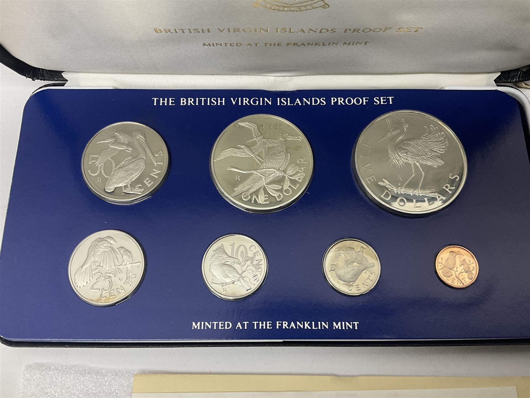 Four British Virgin Islands proof coin sets, comprising First Coinage of the British Virgin Islands 1973 proof six coin set, containing silver one dollar coin, 1977 and 1979 proof sets, containing high denomination silver coins, and The Royal Coronation Jubilee 1977 six coin silver proof set, each minted at the Franklin Mint, all cased with certificates, and a Solomon Islands 1978 proof seven coin set, containing silver five dollar coin, minted at the Franklin Mint, cased with certificate (5)