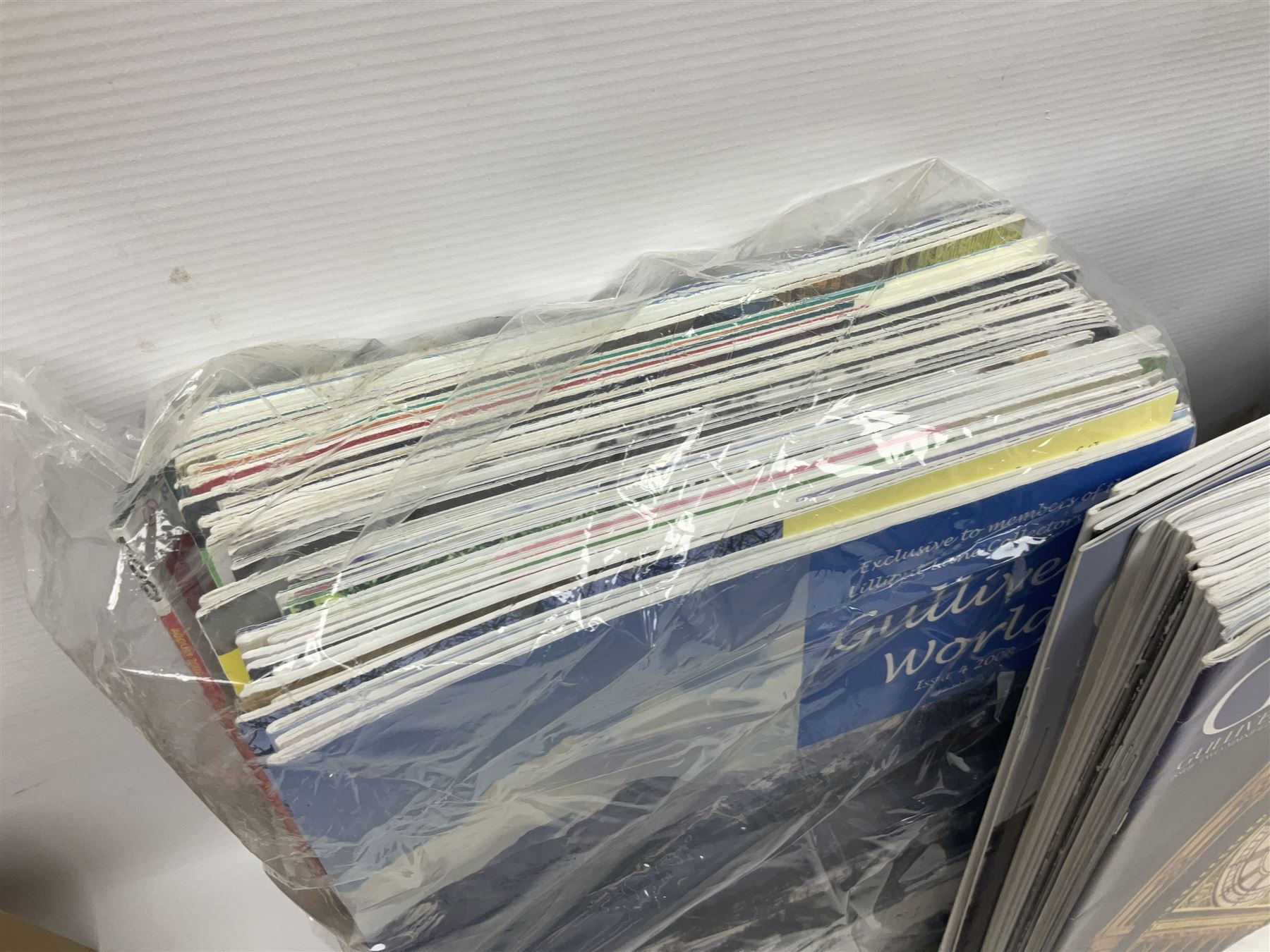 Twenty three Lilliput Lanes, including Village School, Lace's Shoe Shop, Cockles & Muscles, Scotland the Brave etc, together with The Leonardo Collection Paint Box Poppets and Gullivers World magazines 