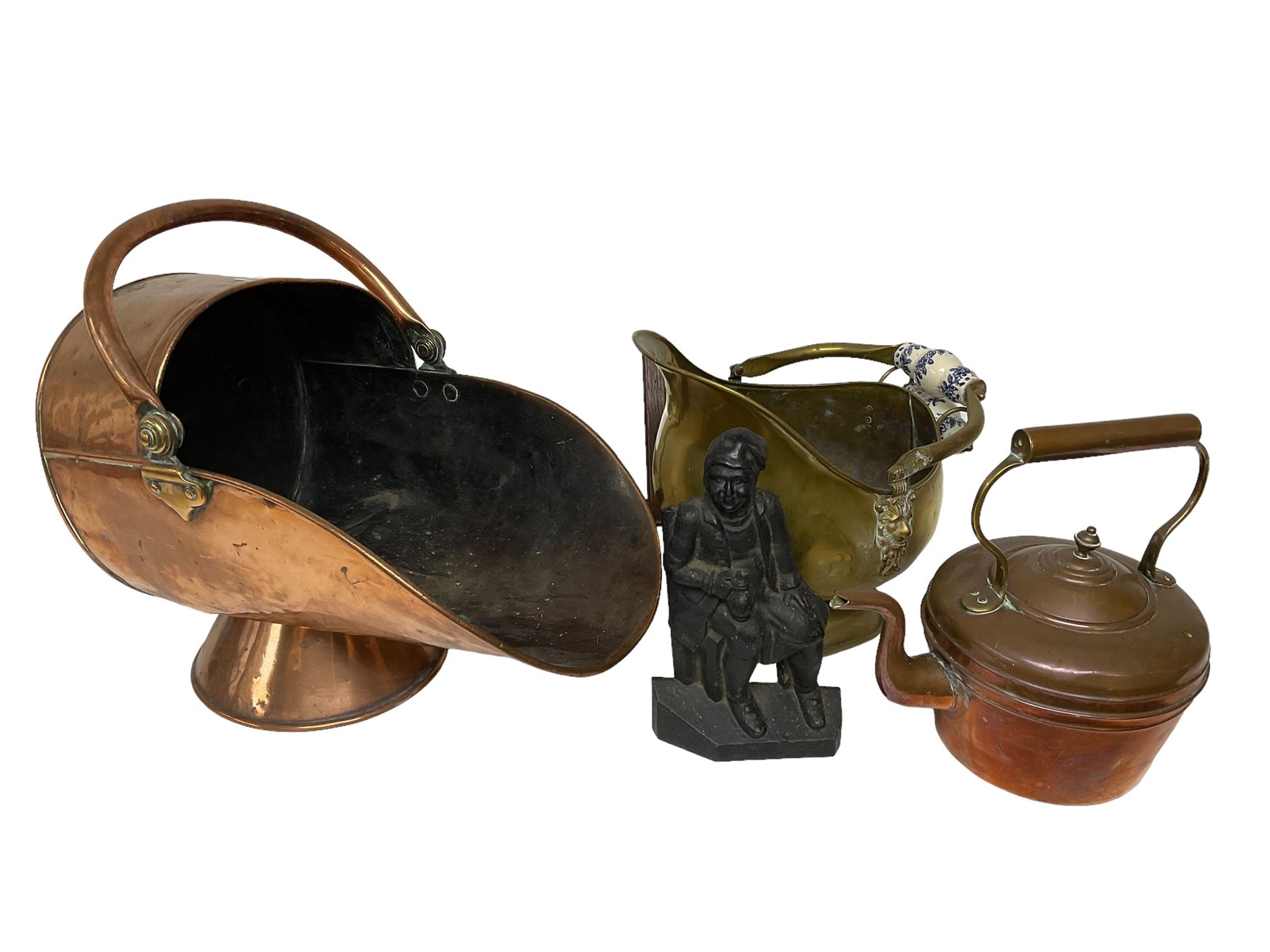 Copper coal scuttle, together with a brass example with lion masks and ceramic handles, iron doorstop, kettle, and framed silhouette picture