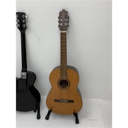 Hohner Arbor Series electric guitar in black and elm effect, serial no.E714703, L101cm; together with an acoustic guitar L102cm; with two Kinsman folding stands (4)