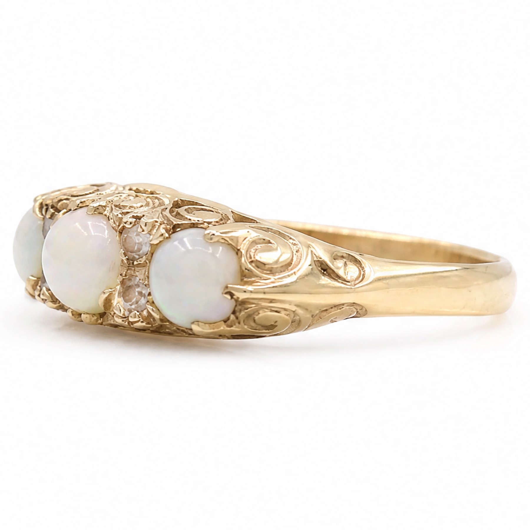 9ct gold three stone opal ring, with four diamond accents set between, Birmingham, 1971