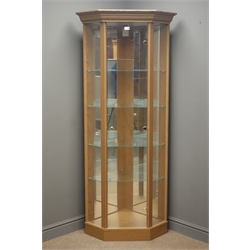  Oak finish illuminated corner display cabinet, enclosing four glass shelves, two full length display mirrors, plinth base, W81cm, H184cm, D60cm  
