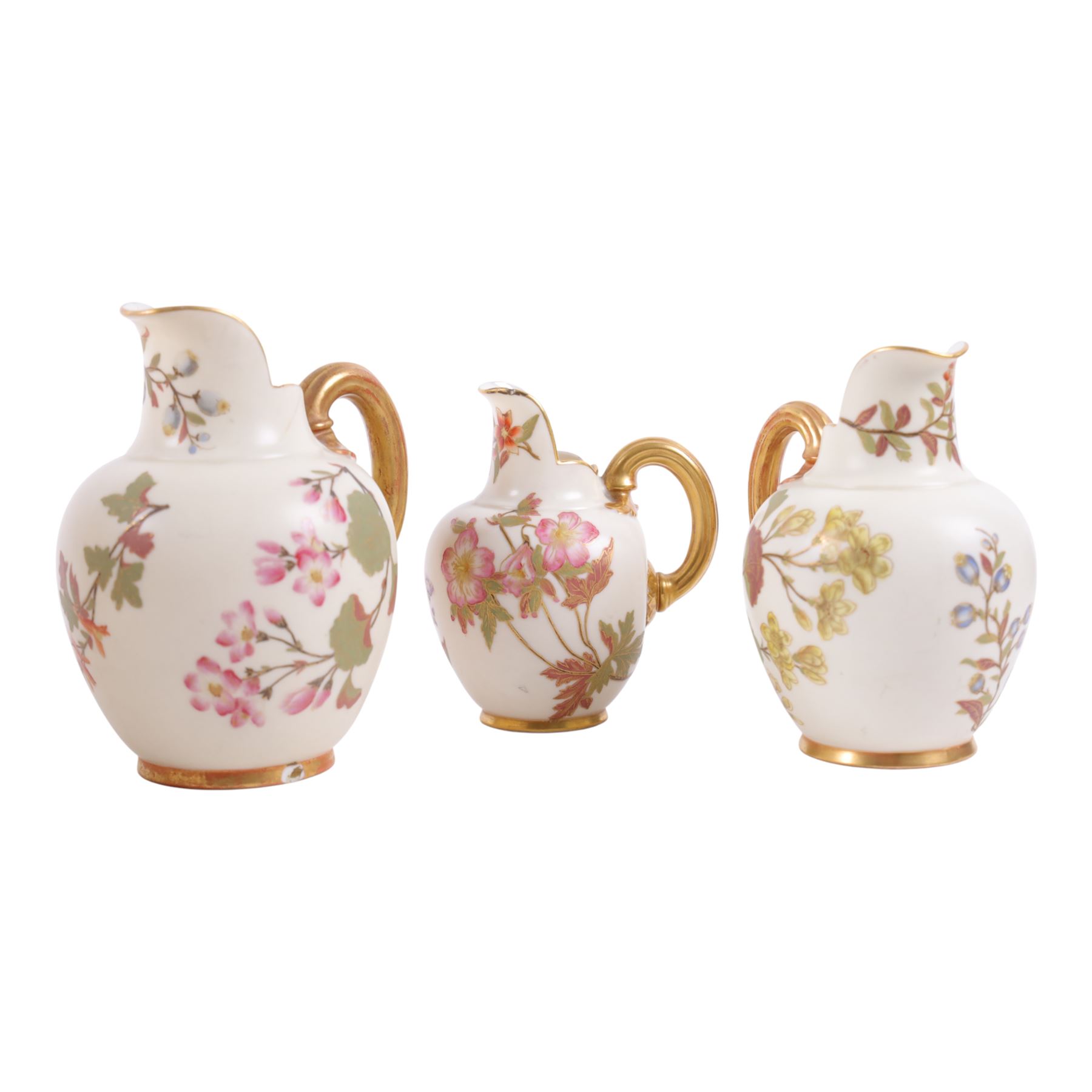 Five Royal Worcester Blush Ivory jugs, shape 1094, each decorated with floral sprigs and with gilt handles , all with puce mark to base, tallest H18cm