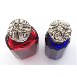 Victorian ruby glass facet cut scent bottle, the silver foliate embossed hinged cover lifting to reveal a stopper, together with a similar Victorian blue glass example with stopper, each approximately H6cm, (2)