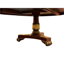 Large Neo-Classical design parcel gilt mahogany 11' 5'' boardroom or dining table, oval moulded top with figured mahogany crossband, turned and leaf carved pedestal supports on concaved triangular platforms with moulded edge, on scroll carved feet, sits sixteen