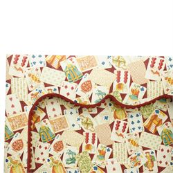 Late 20th century upholstered window pelmet with internal blind and side drapes, covered in a playing card patterned fabric with scalloped edging and red braid trim
