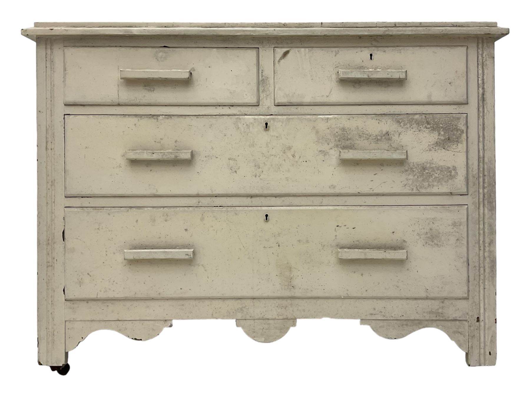 20th century painted pine chest of drawers, rectangular top over two short and two long drawers, scalloped apron, on castors