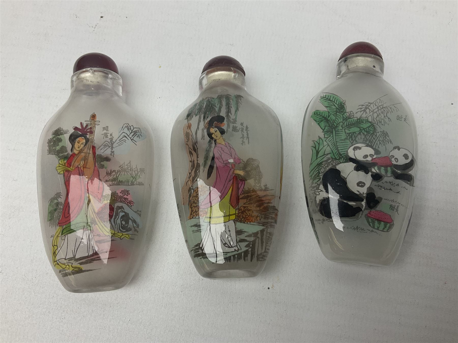 Seven Chinese glass snuff bottles painted with figures and animals, together with three wood mounted bone examples