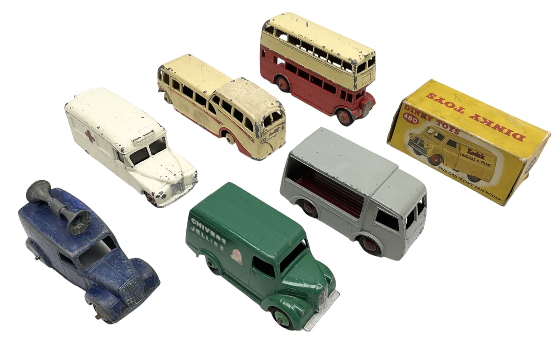 Dinky - Bedford 10cwt Van 'Kodak' No.480, boxed; and six unboxed and playworn models including Trojan Chivers Jellies van, loudspeaker van, Daimler Ambulance, N.C.B. Electric Van and two buses (7)
