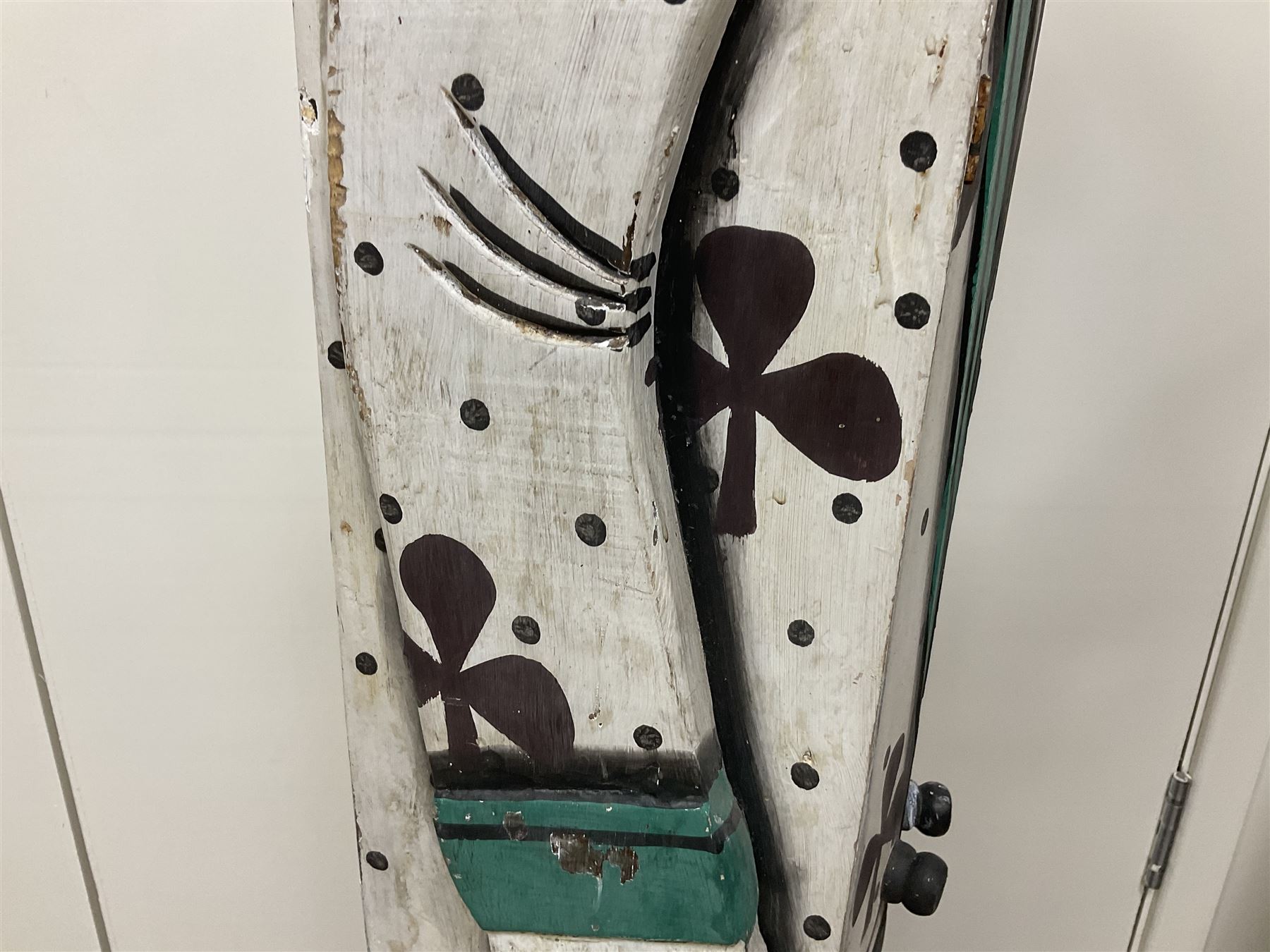Folk art circus clown cabinet, the the two hinged doors with bow tie decoration opening to reveal fitted shelved interior, the body painted with polka dots and spades, H121cm