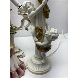Jaffe Rose figural ceramic table lamp, modelled as two putti climbing a column with gilded cloth, together with a Capodimonte floral two light table lamp and a collection of lamp shades