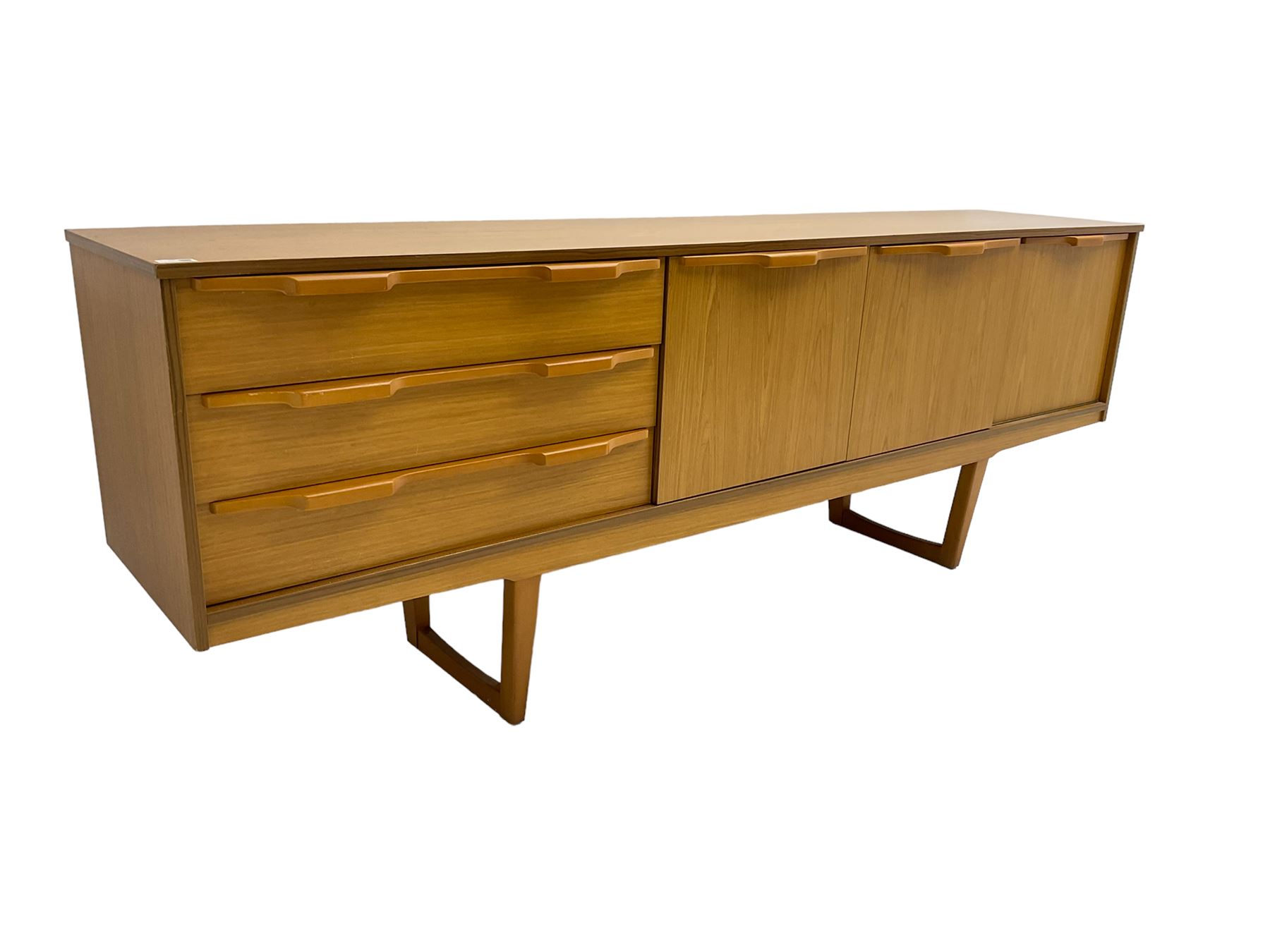 Stonehill Furniture (SF) Ltd - mid-20th century teak sideboard, rectangular topover three drawers, two cupboard doors and fall-front drinks cupboard, raised on square tapering supports
