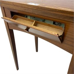 Mid-20th century teak sewing table, rectangular top with hinged fold-out extension revealing built-in Singer sewing machine, fitted with single hinged drawer, on square tapered supports; various Singer accessories to include Fashion Discs and Motor Controller