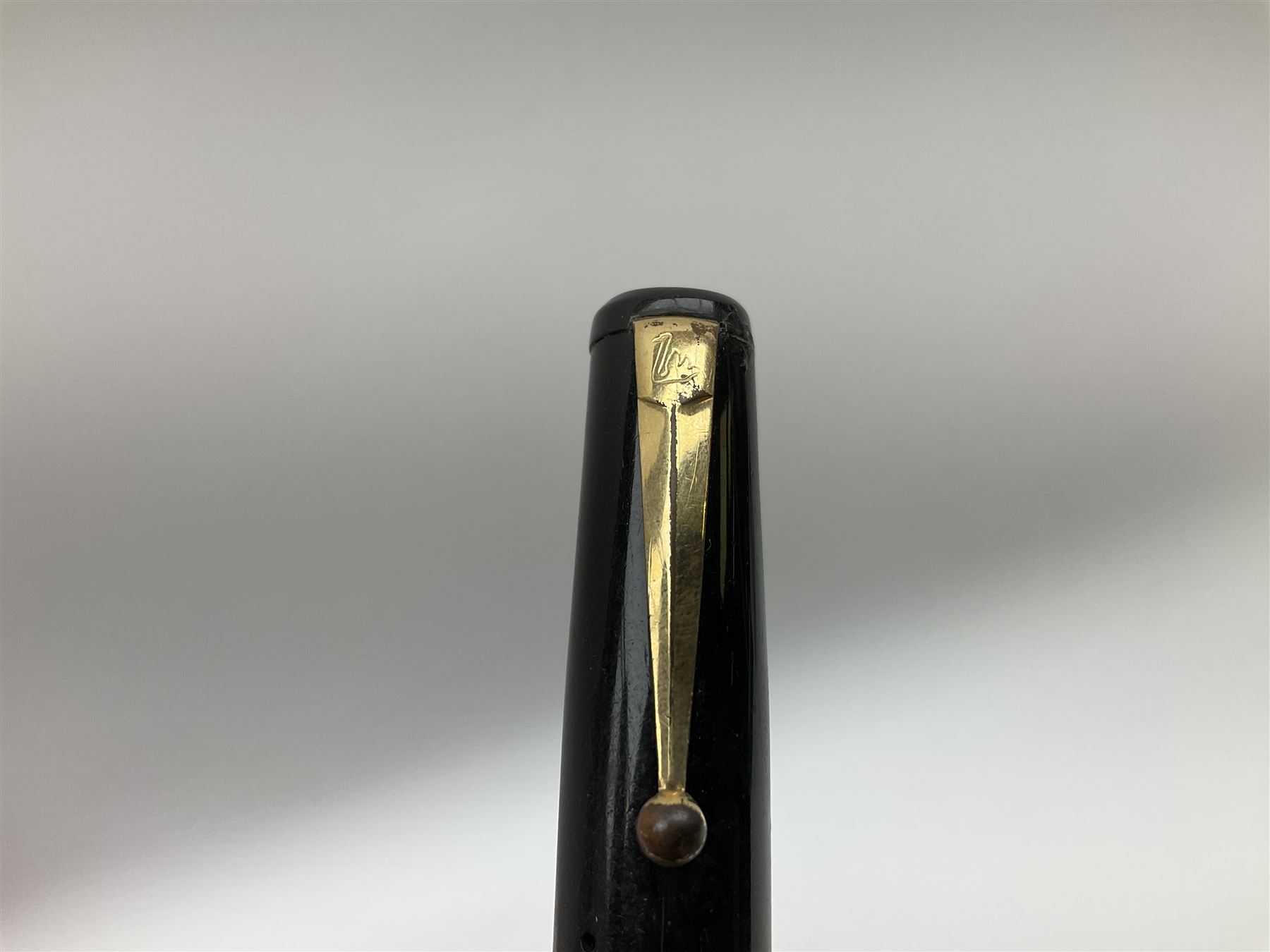 Vintage Swan Mabie Todd lever fill fountain pen in coral red, the nib a/f marked 14K, together with two further vintage Swan Mabie Todd fountain pens, the first example with lever fill, the other leverless, each with black body, one with nib marked 14ct, (3) 