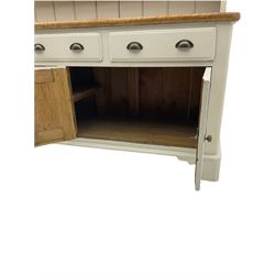 Victorian pine dresser, raised painted three heights plate rack with projecting cornice, waxed top over pained base fitted with three drawers and two double cupboards, bracket feet
