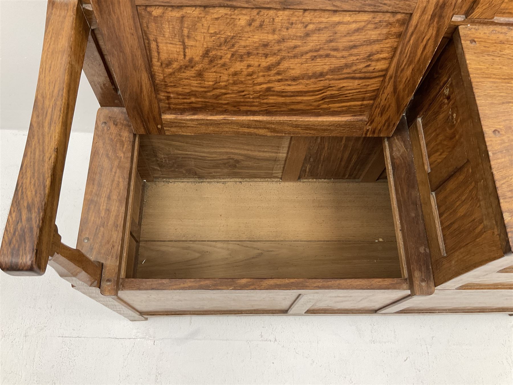 'Acornman' figured oak telephone table, panelled back above hinged seat and two drawers, panelled sides and front, all over adzing, by Alan Grainger of Brandsby, York