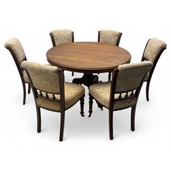 Victorian mahogany centre table, circular top above turned pedestal, terminating on three cabriole legs with scroll feet on porcelain castors, and six scroll carved upholstered dining chairs, with cushion and spindle turned backs, centre table  118x74cm, dining chairs 89x46x50cm