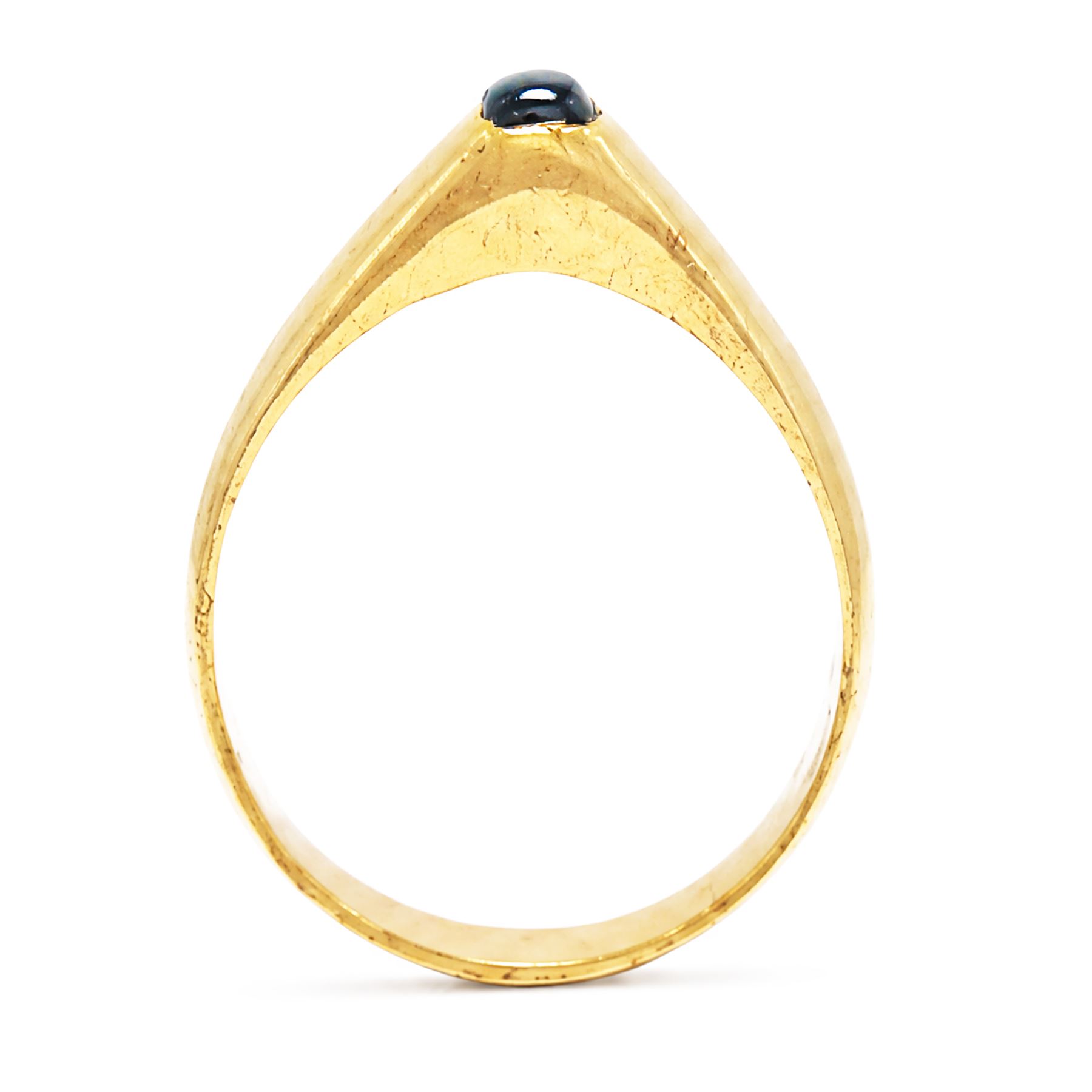 Medieval gold sapphire stirrup ring, circa. 1150-1500, the hoop of ‘D’ shaped cross-section, with raised triangular shaped bezel centred at the apex with a cabochon sapphire