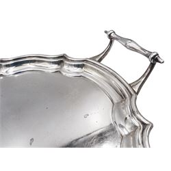 1930's silver twin handled tray, of oval form with pie crust rim, upon four stepped pad feet, hallmarked Barker Brothers Silver Ltd, Birmingham 1933, including handles H7cm, L51.7cm, W31cm, approximate weight 54.68 ozt (1700.8 grams)