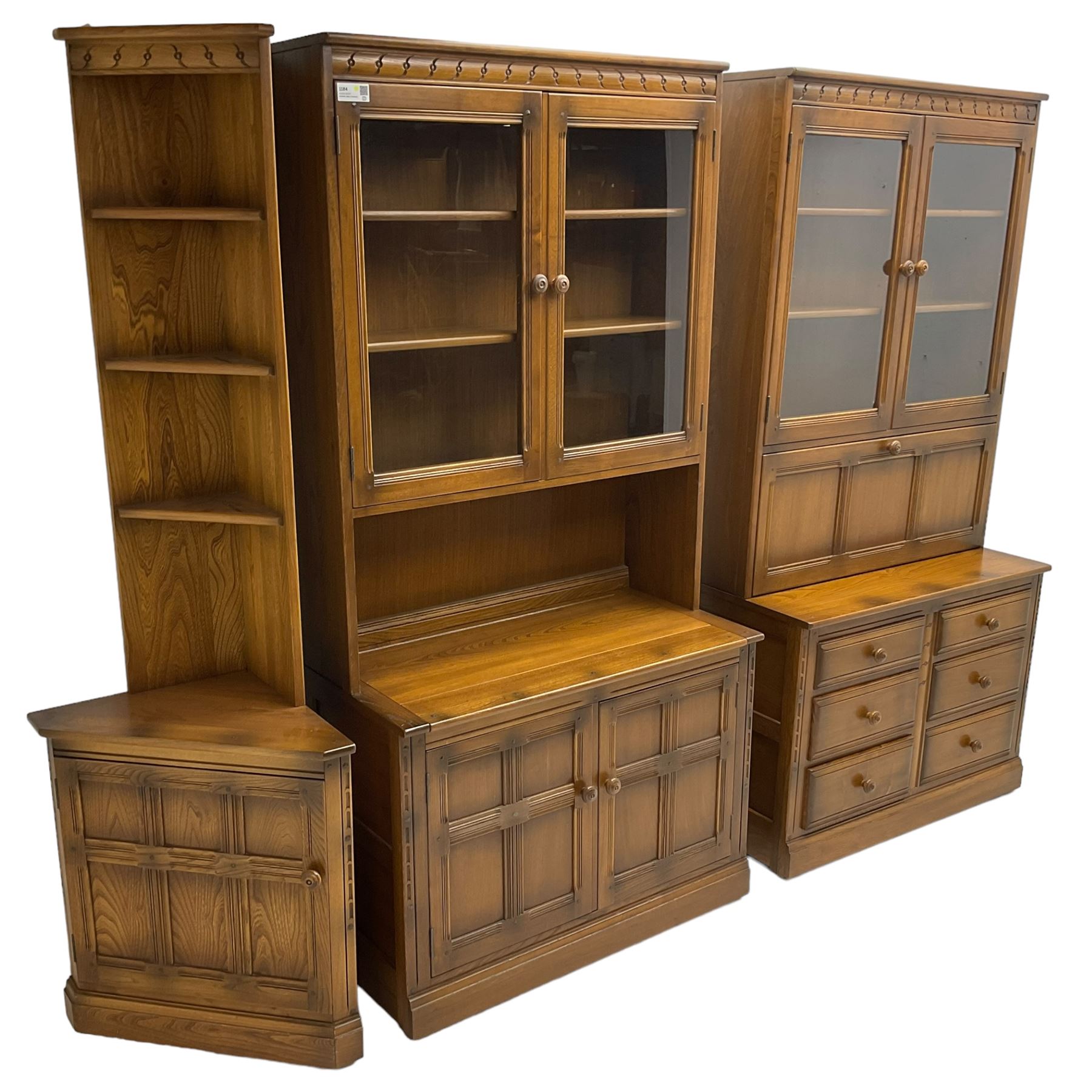 Ercol - mid-20th century dark elm 'Old Colonial' three sectional wall display unit, comprising two units and corner unit, fitted with open shelves, glazed cupboards and drawers