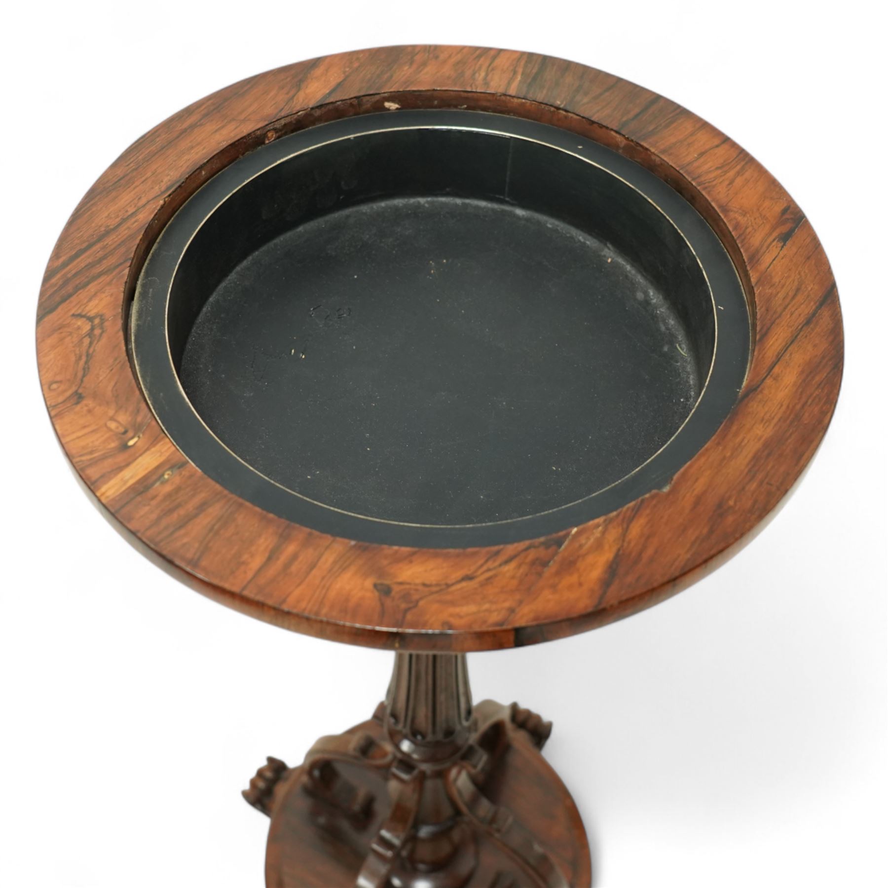 An early Victorian rosewood plant stand with removable marble top, with metal interior liner, circular top above fluted column with arched scroll supports on turned base with scroll feet 