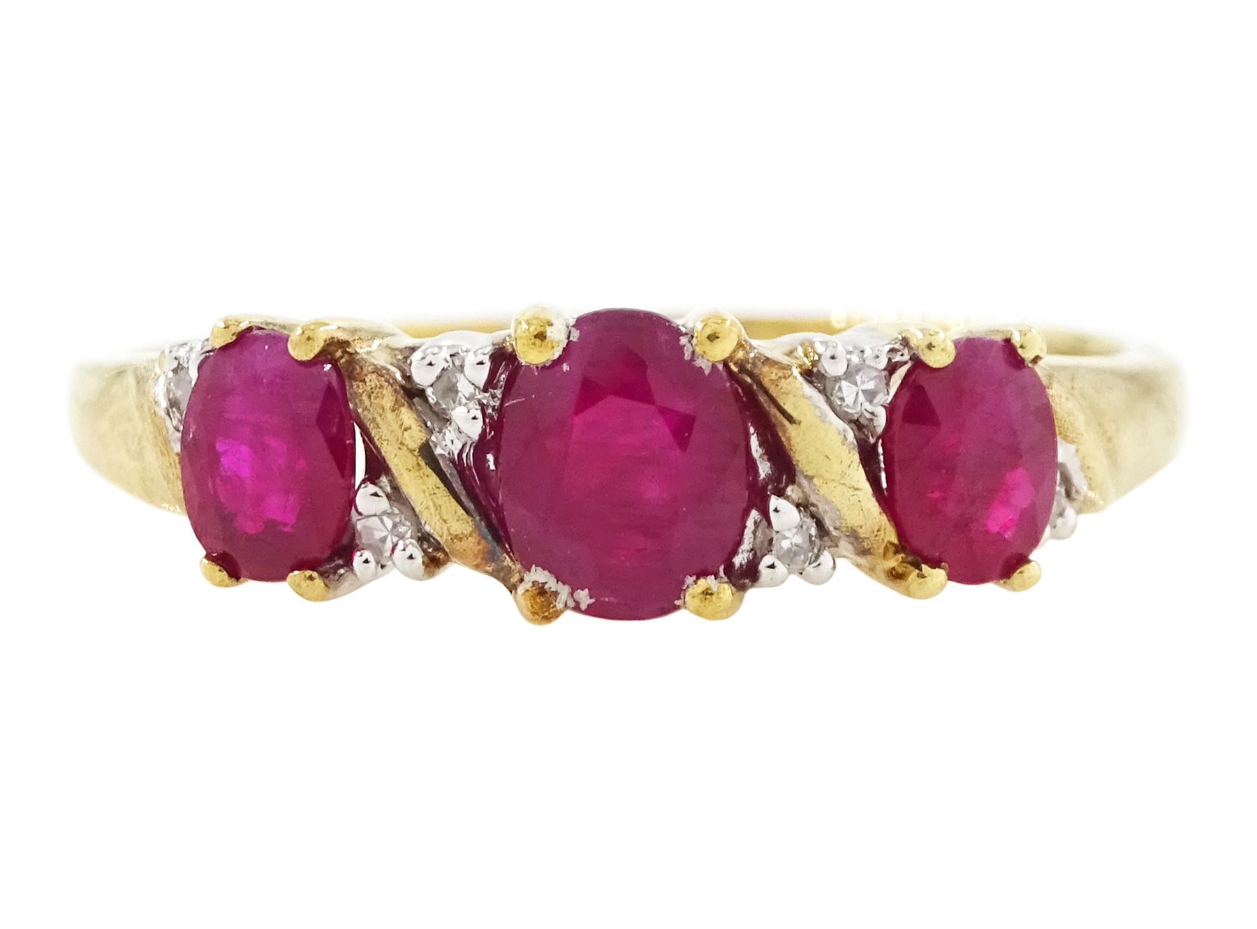 9ct gold ruby and diamond ring, three oval cut rubies spaced by six accent diamonds, stamped 9k