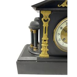 French - 8-day late 19th century slate mantle clock, with an architectural pediment surmounted by a dome and finial, semi-circular rotundas to the sides on a deep rectangular stepped plinth, with cast brass decoration to the tympanum and dial, enamel chapter, gilt centre, Arabic numerals and pierced steel hands, eight-day French movement striking the hours and half-hours on a coiled gong.  With pendulum.