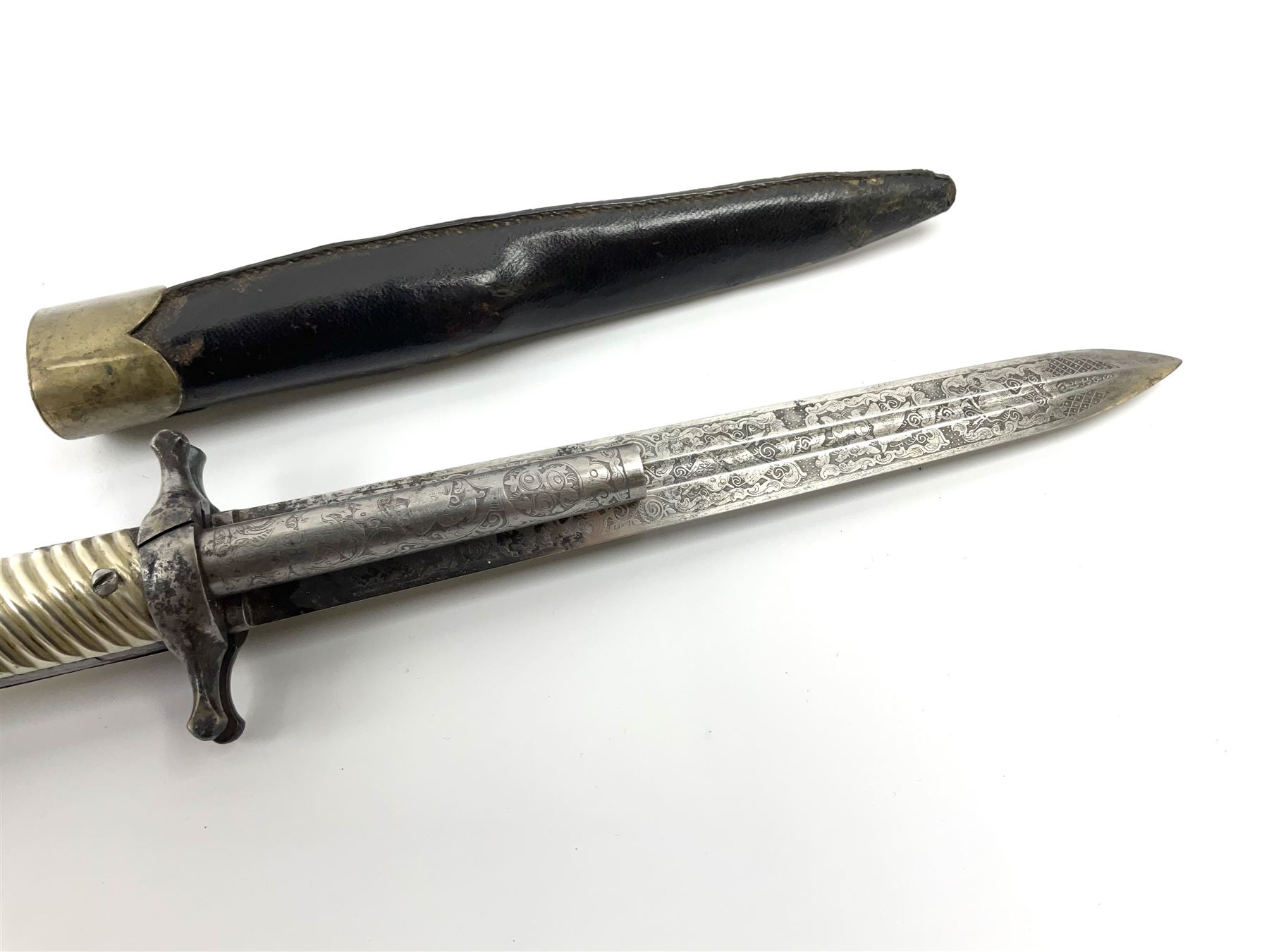 Rare double barrel percussion knife pistol by Dumonthier & Sons (NVN), approx. .38 calibre, with 8.5cm barrels and central 21.5cm spear pointed blade, all with etched damascening, upper quillons serve as hammers for the percussion ignition with single drop down trigger and fluted nickel grips, in nickel mounted leather covered tin scabbard L33.5cm overall