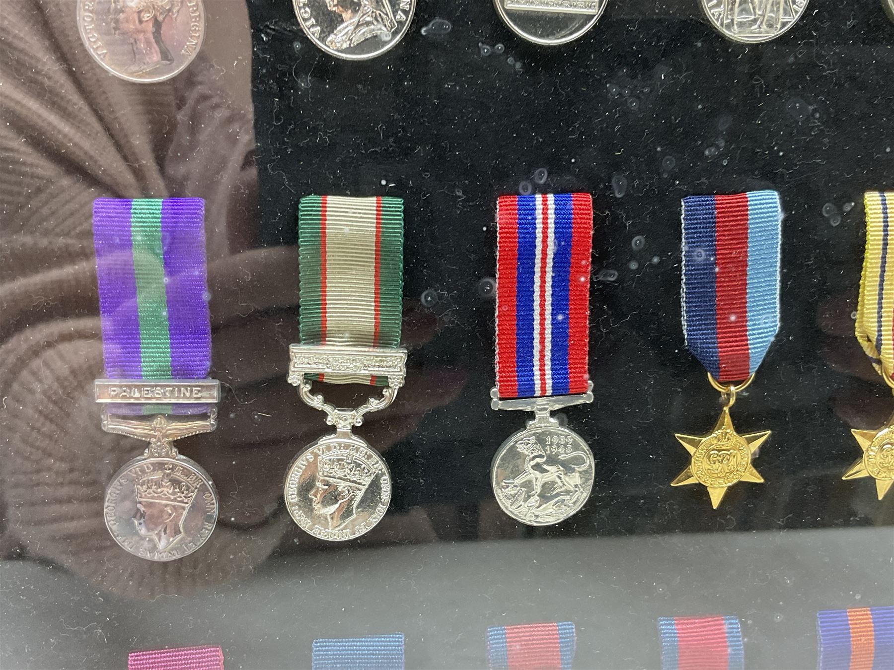 Limited edition large framed display board with sixty half-size copies of British Gallantry and Campaign Medals produced by Danbury Mint; all with ribbons and associated booklet