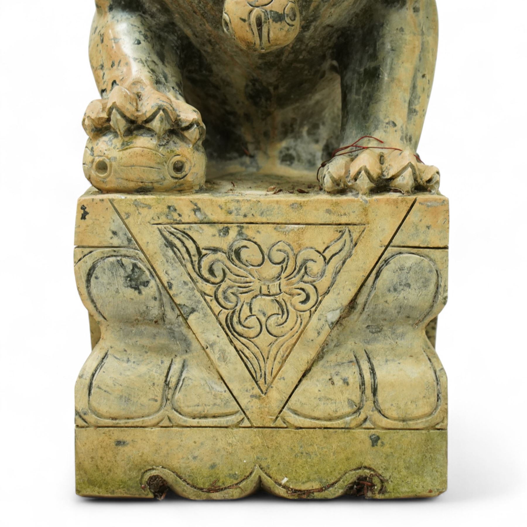 Pair of Chinese hardstone carved Foo dogs, each finely carved seated on rectangular plinth bases with detailed manes, collars and bells, the male with paw resting on a ball, the female with cub, in mottled green stone resembling jade