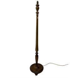 Early 20th century walnut standard lamp, turned column on a circular base with splayed feet, with shade