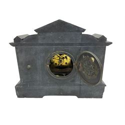 Slate mantle clock c1890 with an American “Waterbury” eight-day spring driven movement striking the hours on a gong (missing) Architectural styled case with recessed reeded brass columns to the front and depiction from Greek mythology to the tympanum, two-part dial with Arabic numerals to the chapter ring and a decorative gilt centre. With Pendulum.