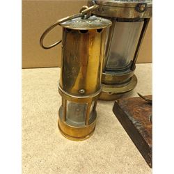 Miners lamp, with plaque numbered 173, together with a miniature brass miners lamp and a wooden paperweight with applied brass miners lamp, pick axe and shovel