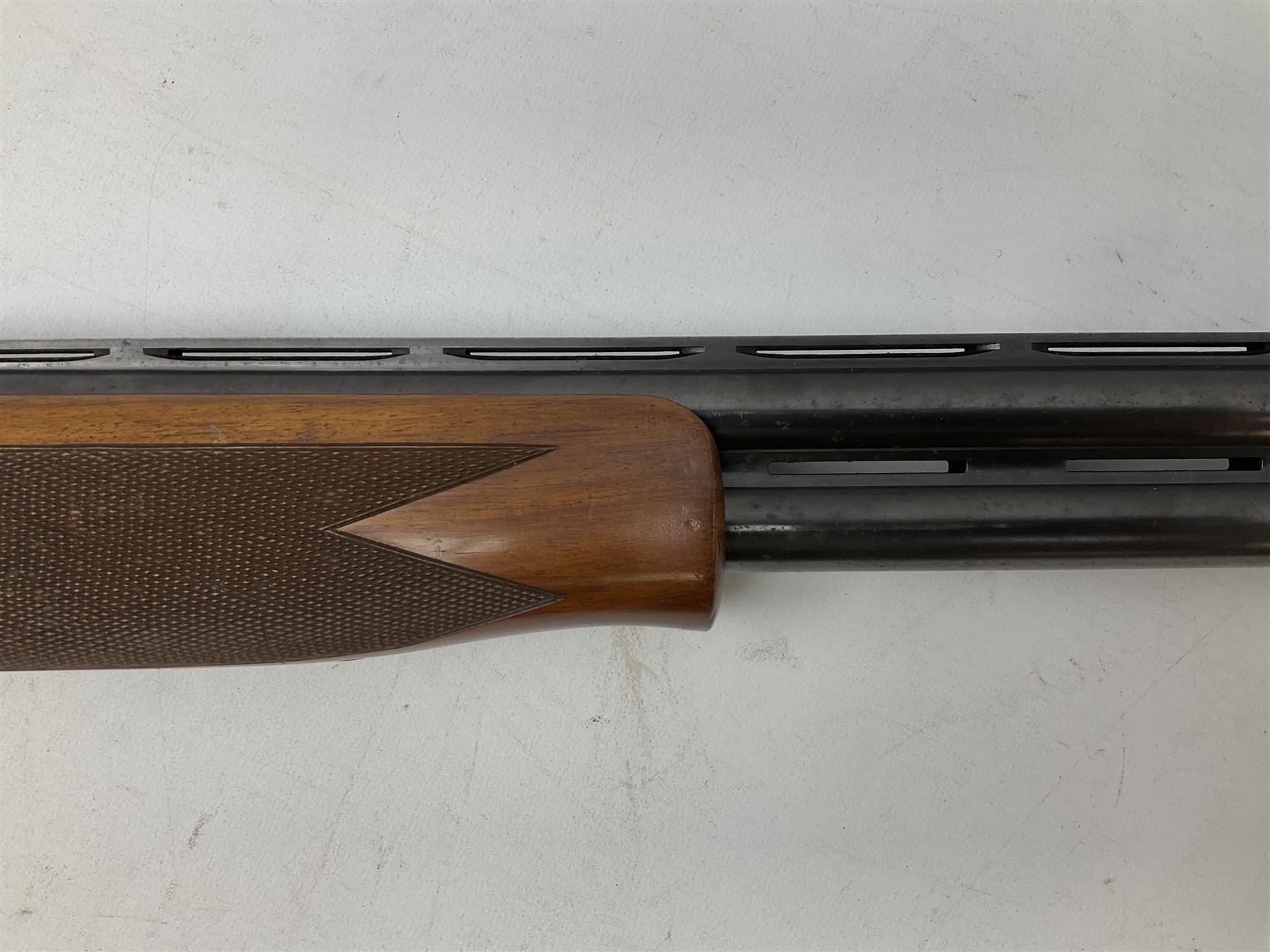 Winchester Japan 5500 12-bore by two-and-three quarters over-and-under double barrel boxlock ejector sporting gun, with 71cm barrels, ventilated rib and barrels, the walnut stock with chequered pistol grip and fore-end, single selective trigger and top safety, serial no.K542927E, L115cm overall; in gun sling SHOTGUN CERTIFICATE REQUIRED