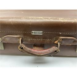 Four vintage suitcases of various sizes  