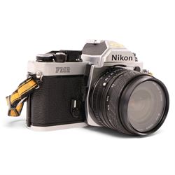 Nikon FM2 film camera body serial no. 7814849 with a Sigma 24mm lens serial no.5083190, camera user manual and Nikon carrying case