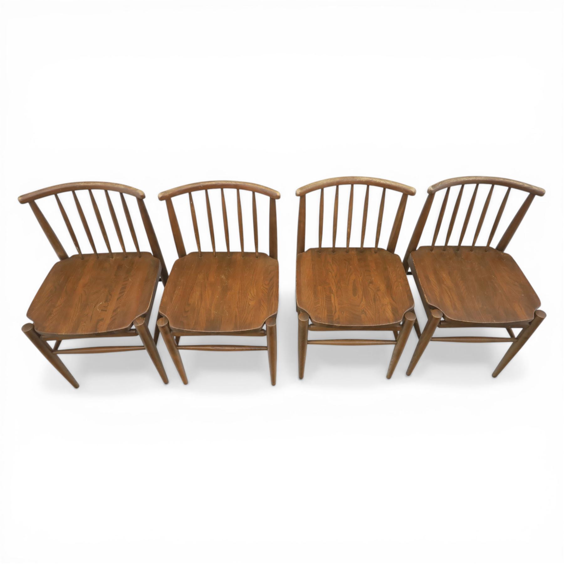Ensign - Mid-20th century elm extending dining table, with fold out leaf, bow ends and sides; and four low stick back chairs, labelled Ensign Bristow & Townsend Ltd, extended 168cm